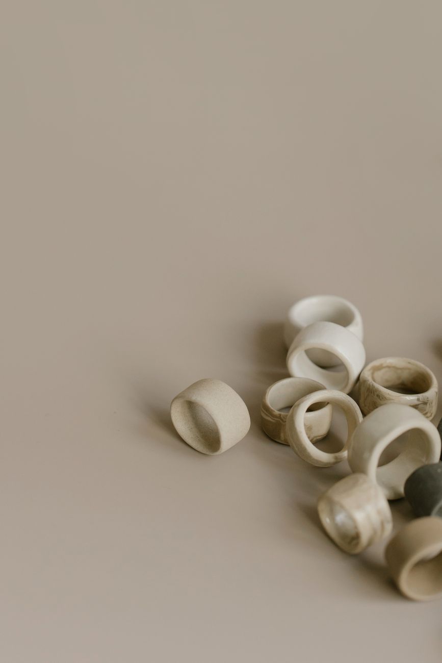 Artistic display of minimalist beige ceramic rings on a neutral background, emphasizing texture and simplicity.. pexels, arti