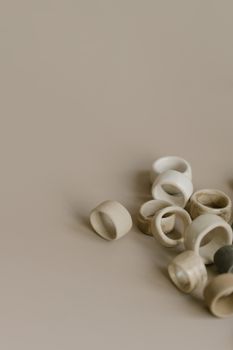 Artistic display of minimalist beige ceramic rings on a neutral background, emphasizing texture and simplicity.. pexels, arti