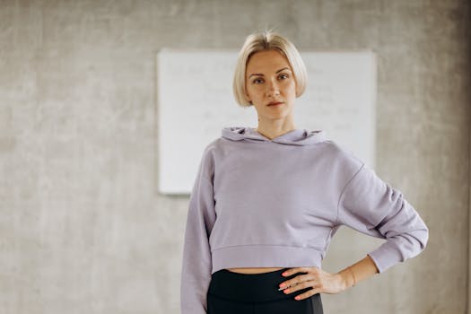 Portrait of a confident female fitness instructor in a gym, showcasing a healthy lifestyle and athletic wear.