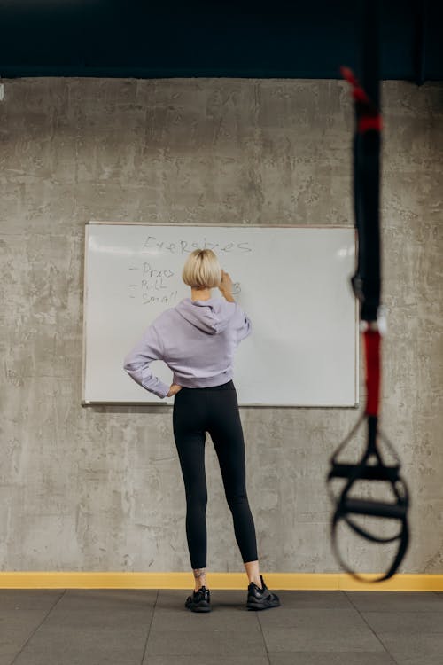 Woman Writing On A Whiteboard