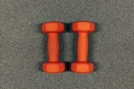Pair Of Orange Dumbbells On Gray Surface