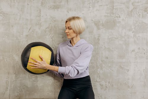 Free Woman Holding An exercise ball Stock Photo