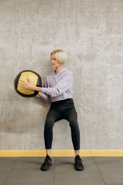 Woman Leaning On Wall With A Ball