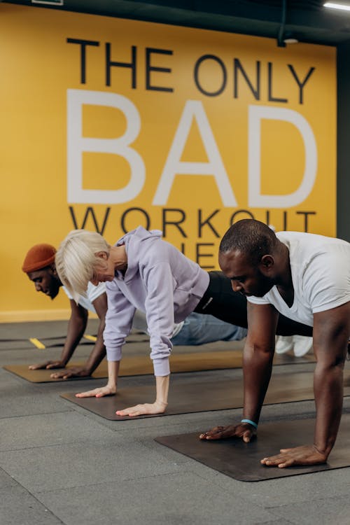 Two Men And Woman Doing Push Up