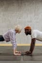 Man And Woman Doing Push Up Face To Face