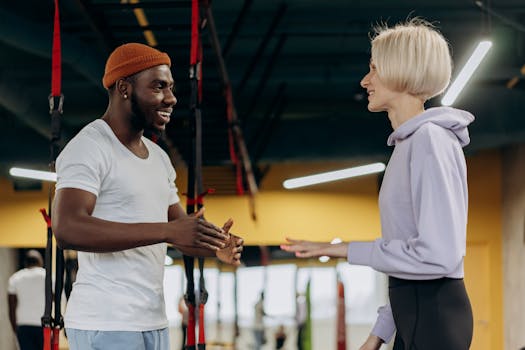 Two fitness trainers conversing indoors, fostering a healthy and active lifestyle.