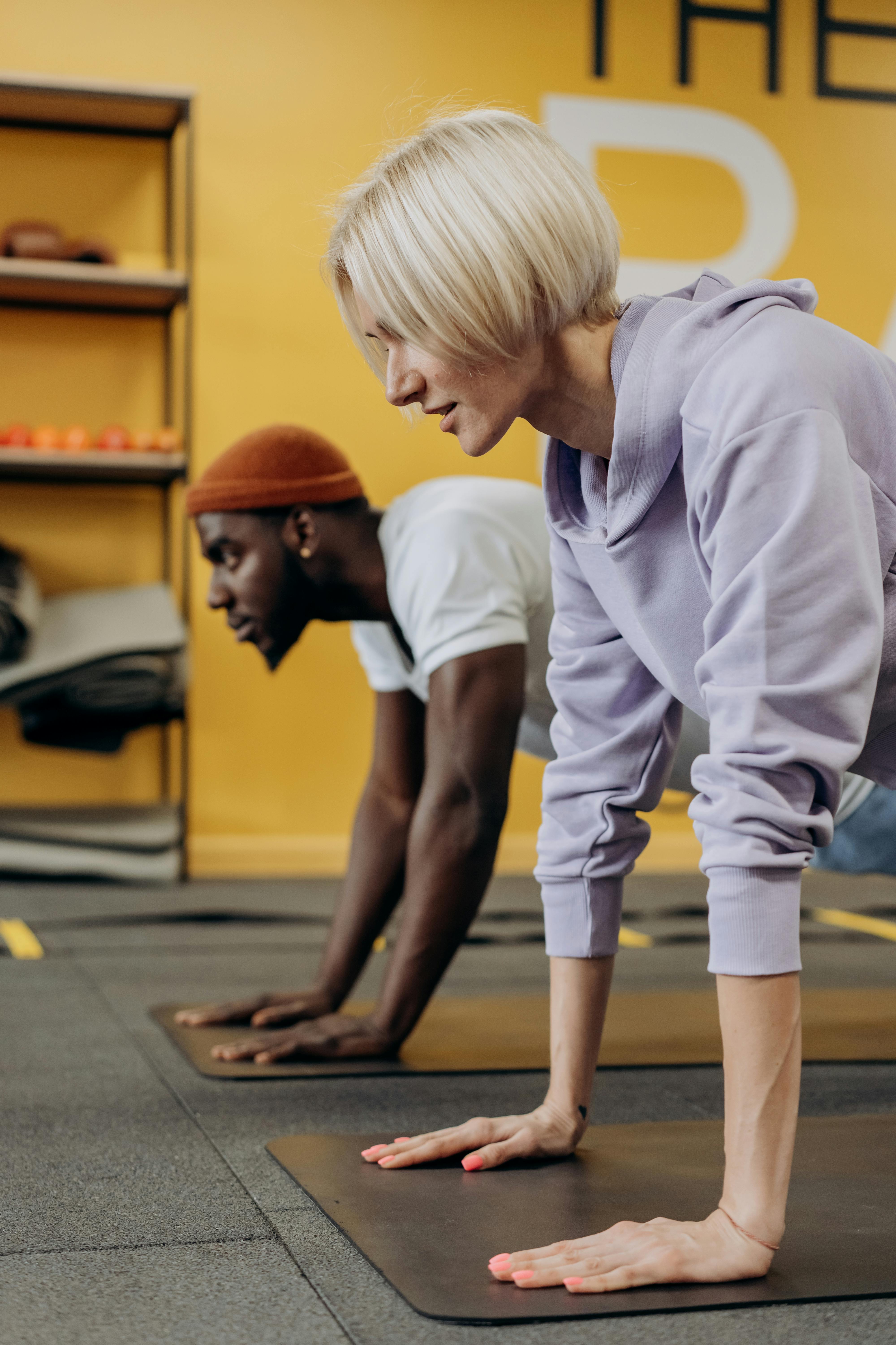 man and woman doing push up