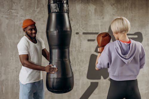 Man Training A Woman In Boxing