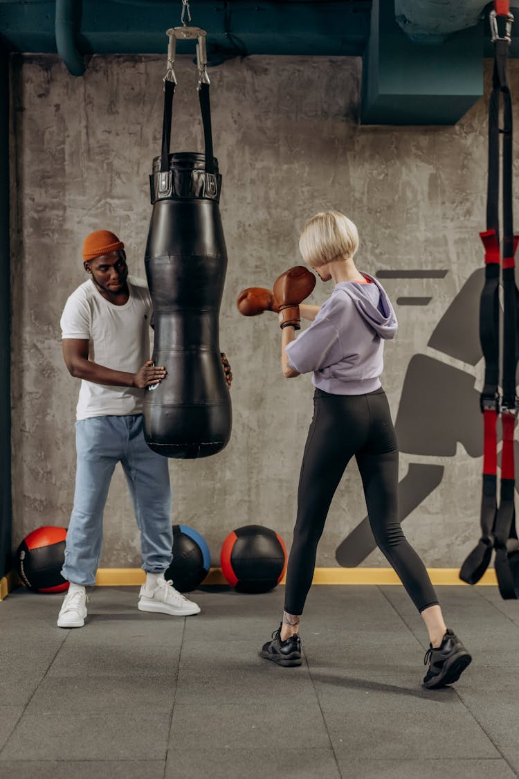 Woman Hitting A Punching Bag