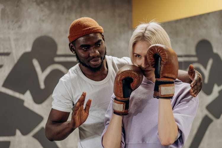 Man Training A Woman In Boxing