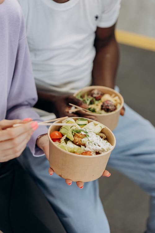 Two People Eating Healthy Food In Bowls