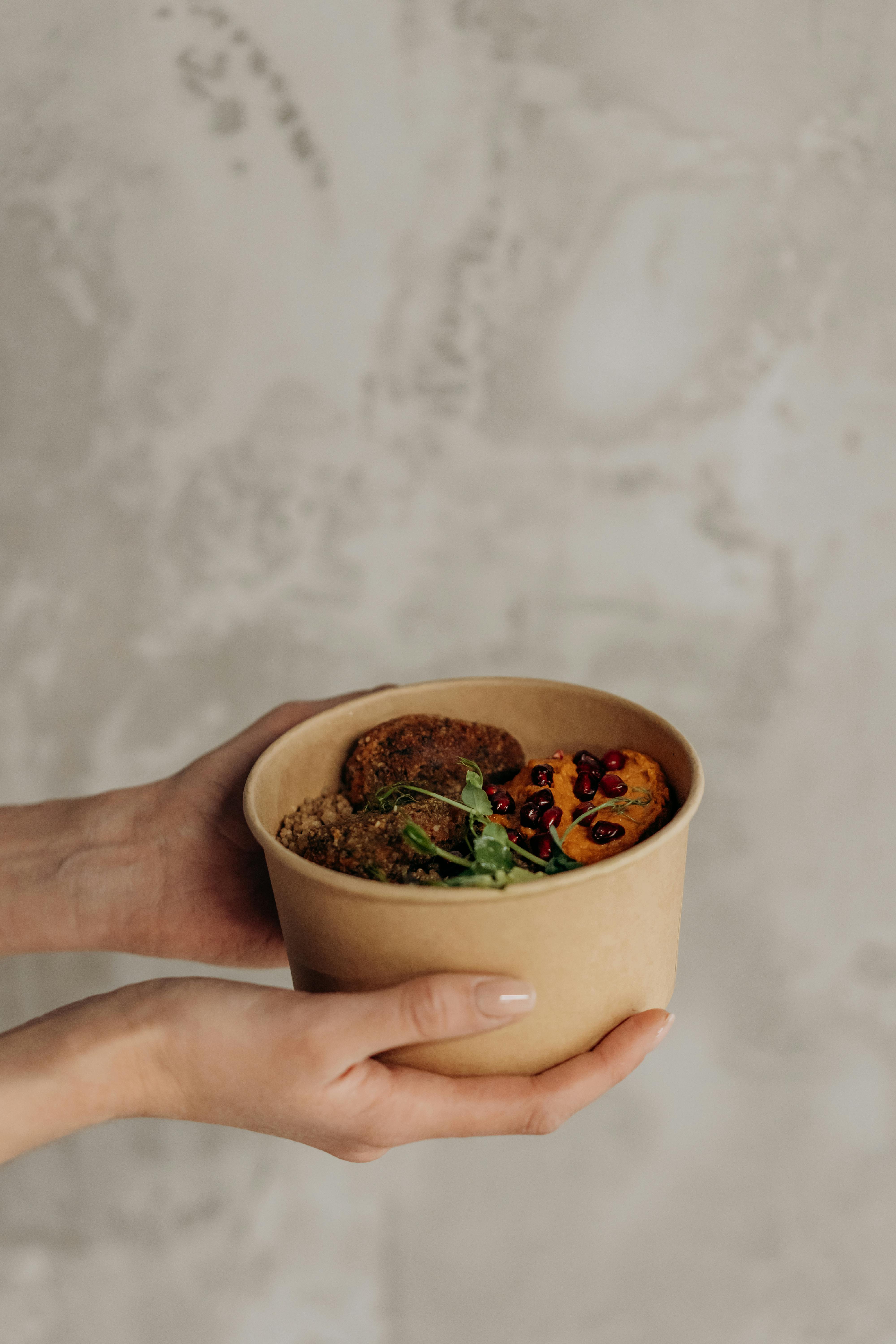 person holding a bowl of healthy food