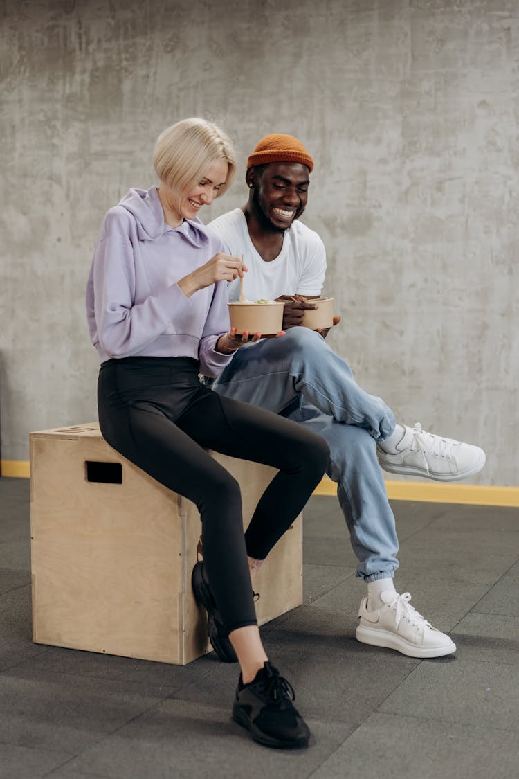 Smiling Man And Woman Eating Together