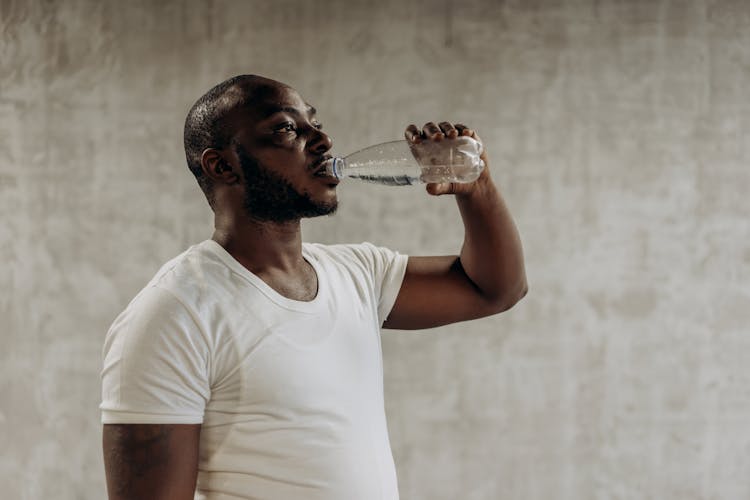 Man Drinking A Bottle Of Water