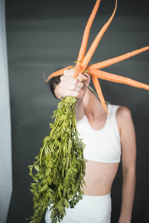 Free A Person with Carrots in the Hand Stock Photo