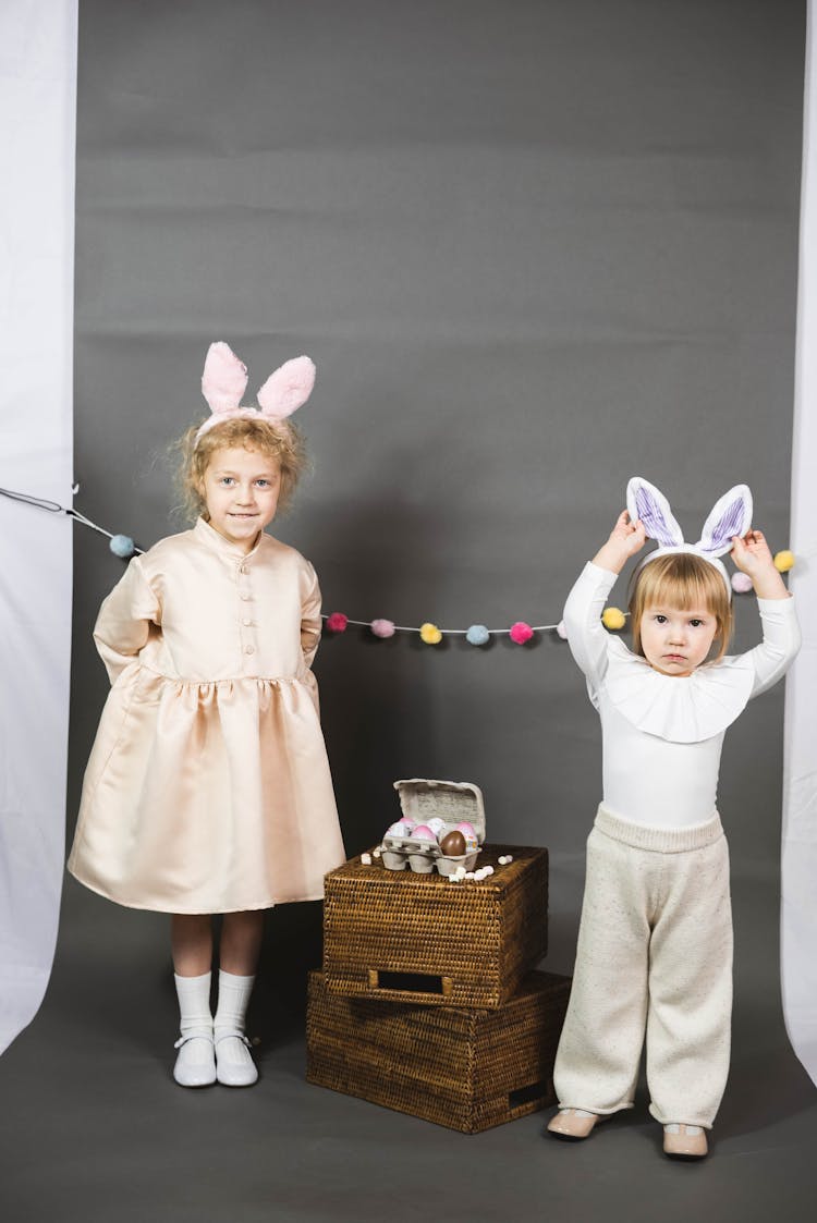 Two Children Wearing Bunny Ears Headbands Standing