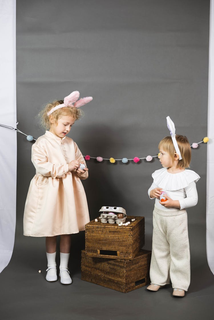 Kids Standing Beside The Woven Crate With Egg Tray On Top