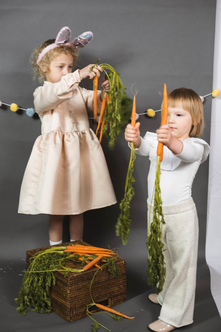 Cute Children Holding Carrots