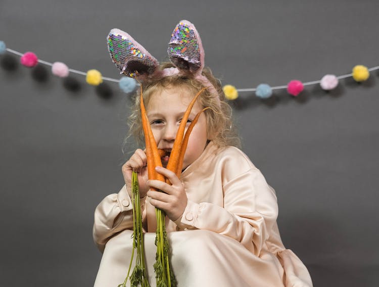 A Girl Eating Fresh Carrot