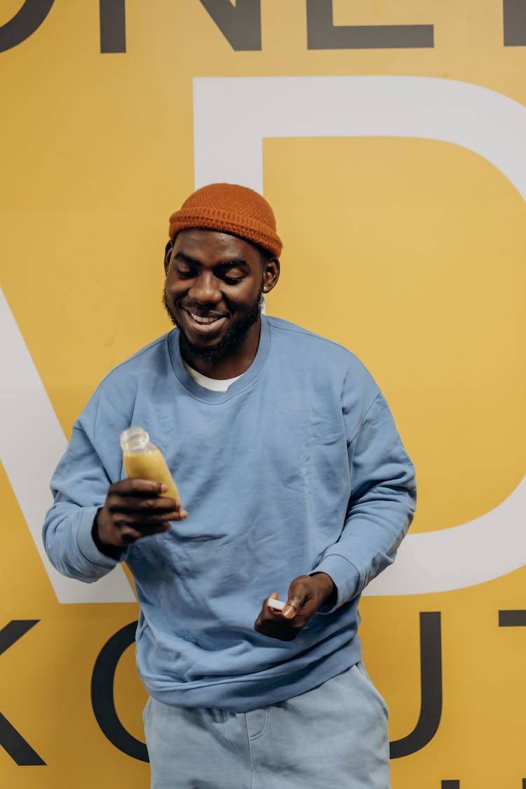 Man Holding A Bottle Of Healthy Drink