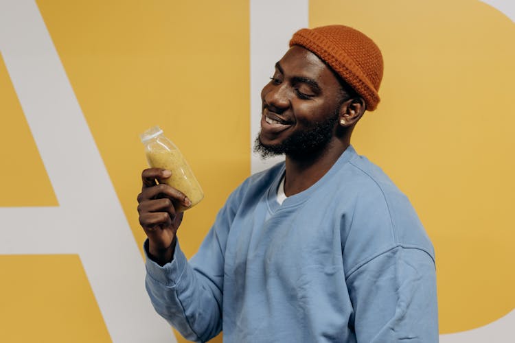 Man Holding A Bottle Of Healthy Drink