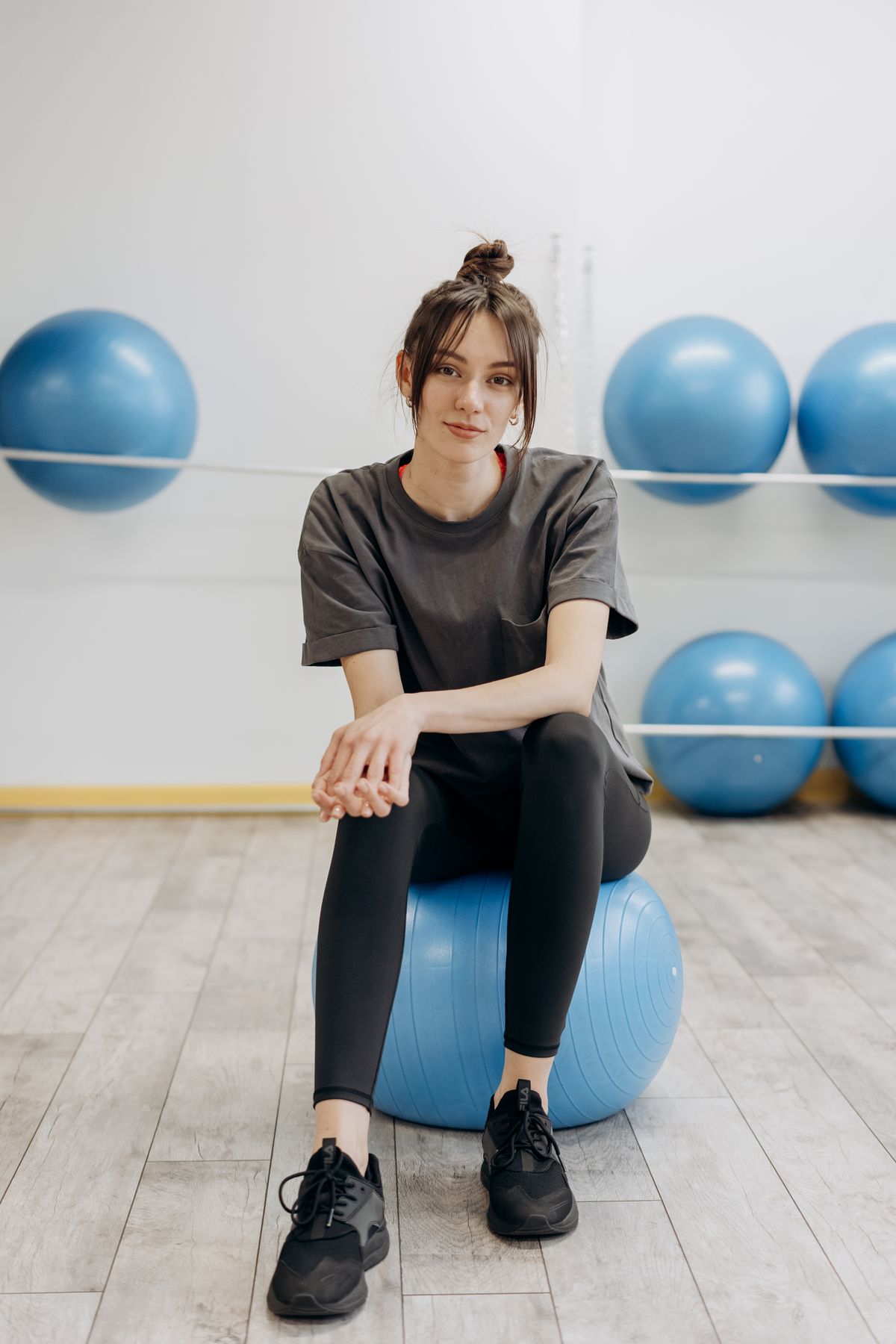 Woman sitting on a blue stability ball