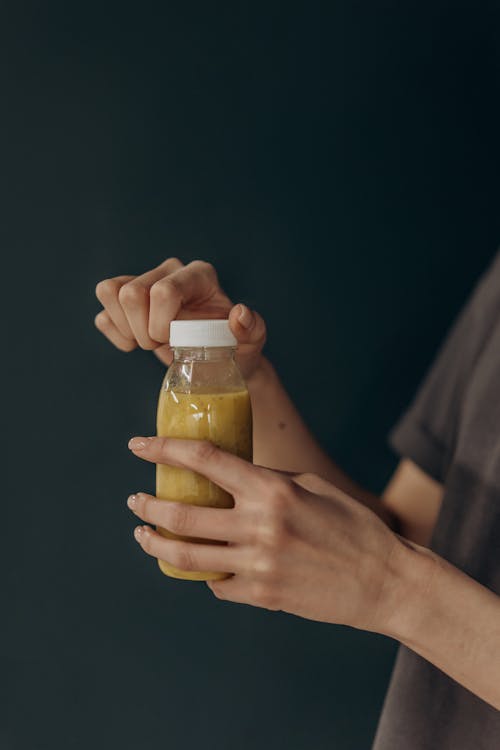 Woman Opening A Bottle Of Juice