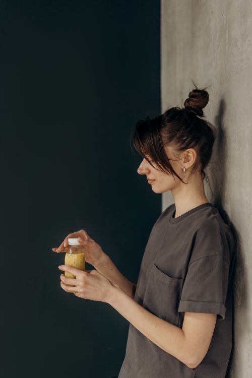 Free A young woman enjoying a refreshing juice indoors, embracing a healthy lifestyle. Stock Photo