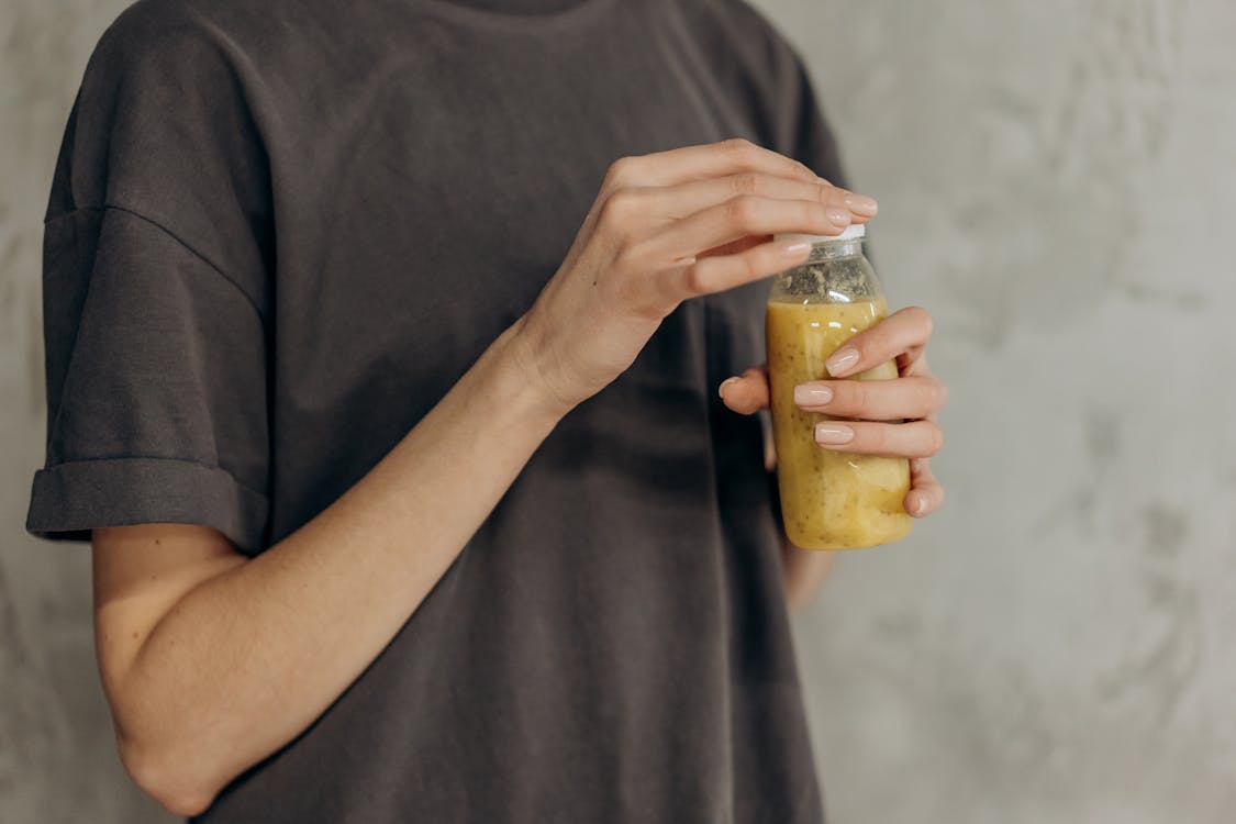 Crop Photo Of Woman Holding A Healthy Drink In Bottle