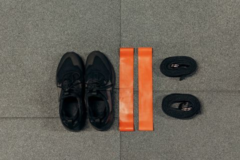 Orange resistance bands laid out beside trainers
