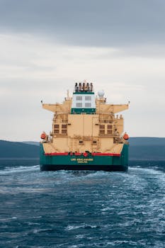 A large cargo ship sails through the blue sea near Çanakkale, Turkey, showcasing global logistics.