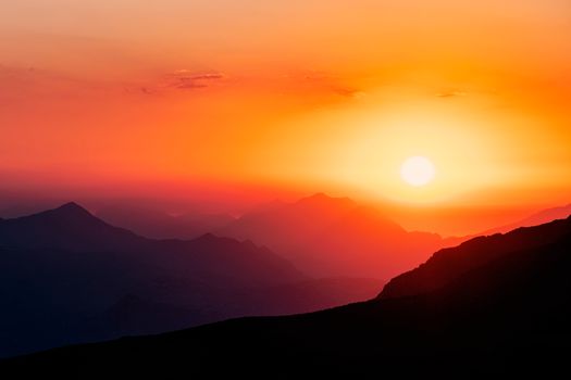 Captivating view of sunset over the mountain range in Mila, Algeria, showcasing vivid colors.
