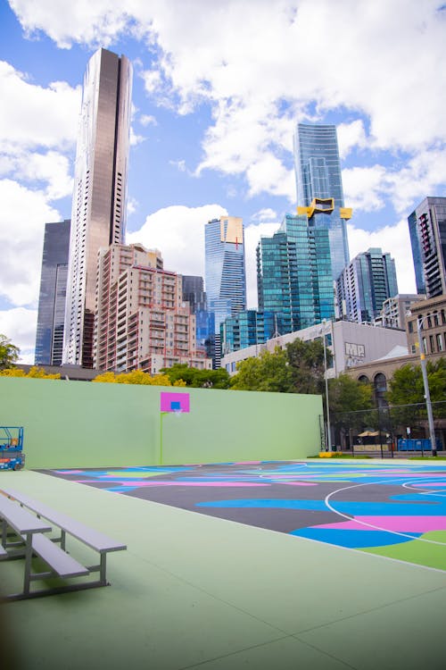 A Colorful Basketball Court Near City Buildings