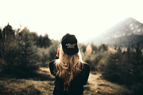 Free Back View of a Woman Black Sweater and Black Cap Stock Photo