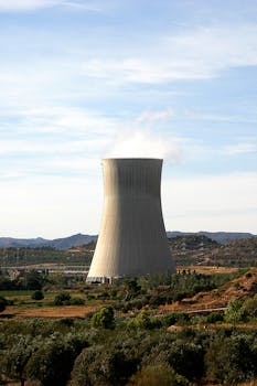 Cooling tower of a nuclear power plant in Ascó, Spain against a rural landscape.
