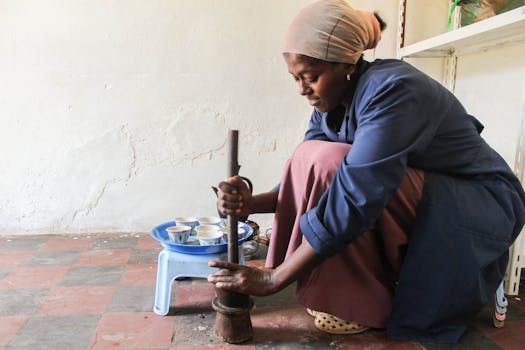 Woman preparing coffee using traditional methods in Addis Ababa, Ethiopia.