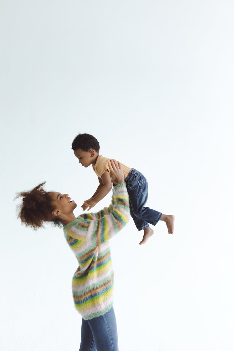 Mother Carrying Her Son Up High 