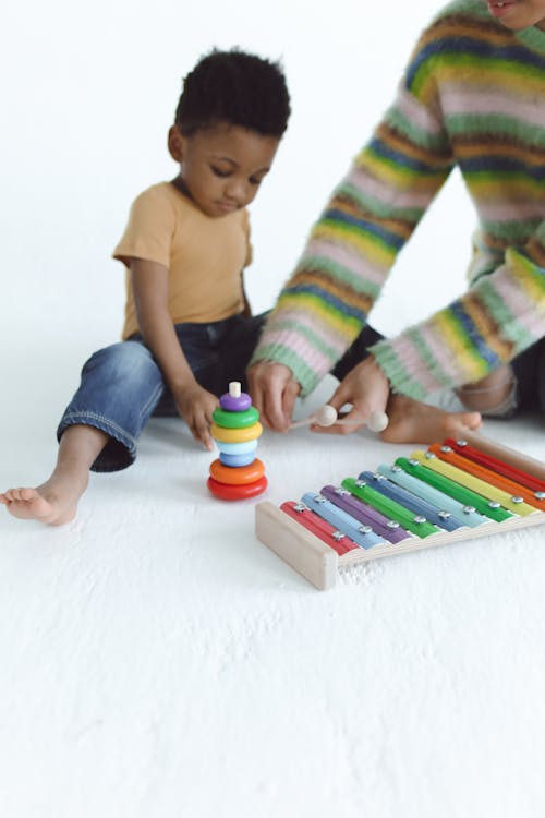 Free Woman and a Child Playing with Toys Stock Photo