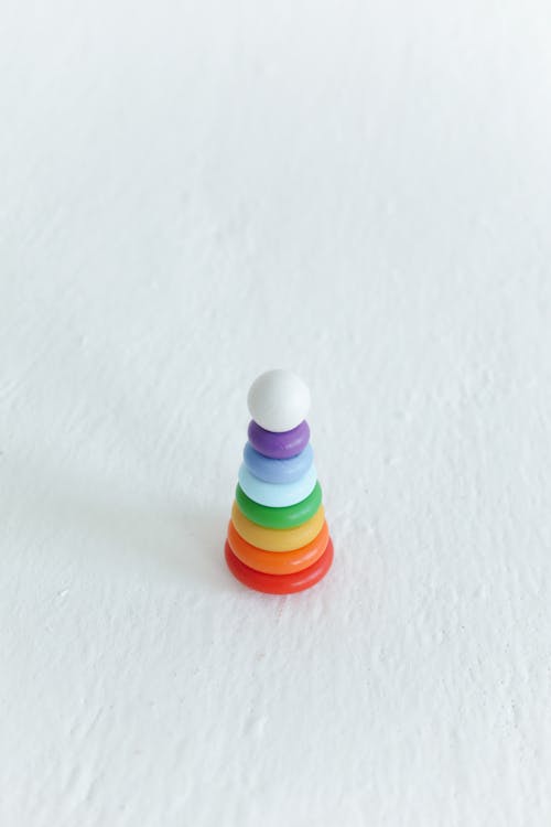 A Colorful Toy Stack over White Surfave