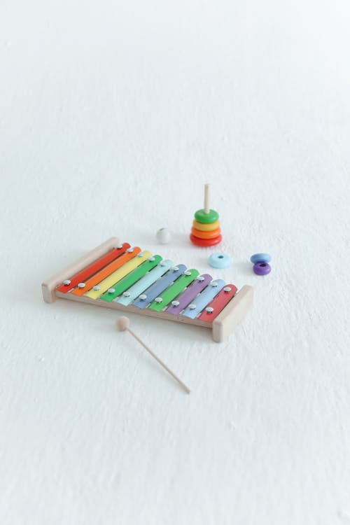 A Xylophone and Ring Toss On White Surface