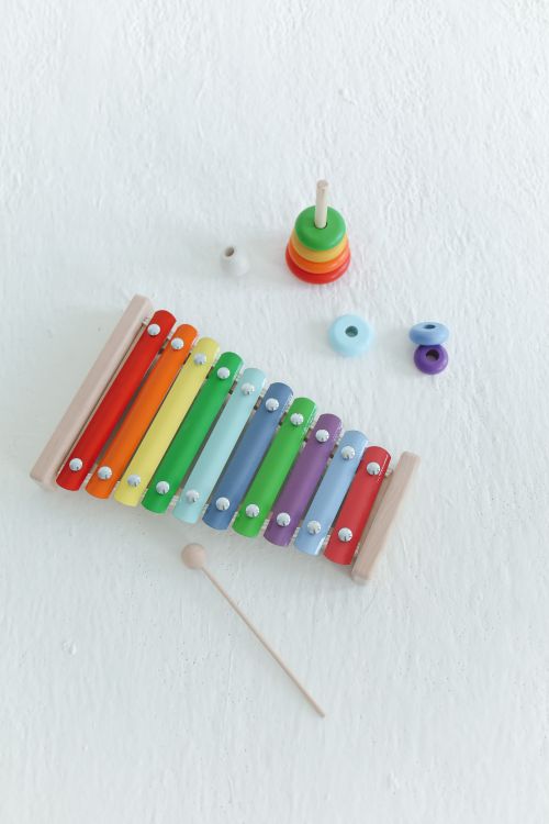 Free Top view of a vibrant wooden xylophone and stacking toy on a white background. Stock Photo