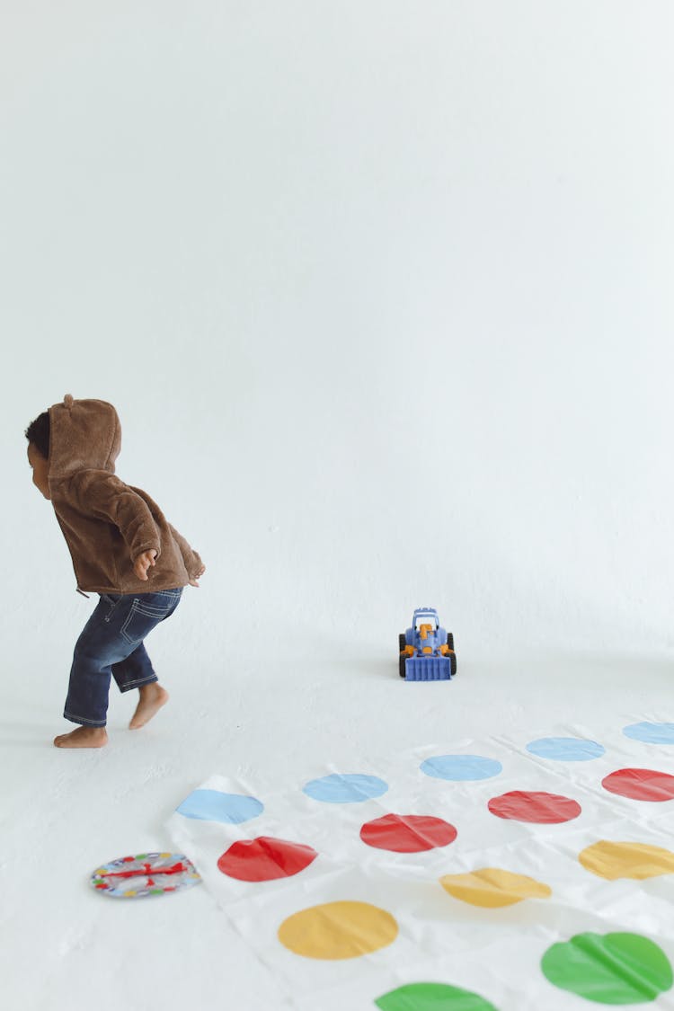 A Child Playing With A Mat Of Colors 