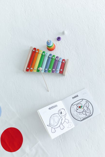 Overhead view of a xylophone and coloring book with kids' activities, toys, and vibrant colors.