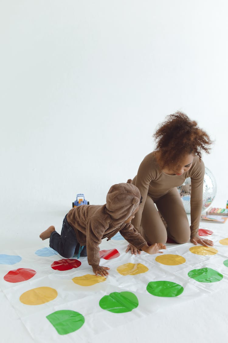 Woman And Child Playing On Polka Dot Mat