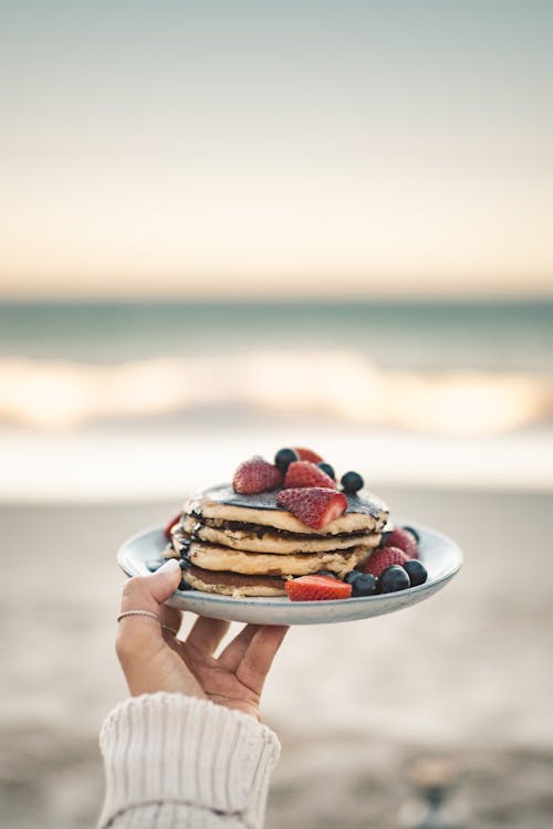 Free Person Holding Plate of Pancakes Stock Photo