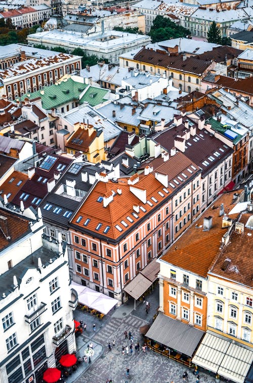 Free Town with historic buildings near road and people on pavement Stock Photo