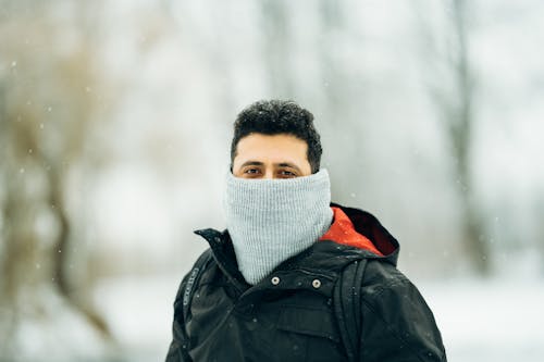 Man in warm outerwear in winter park