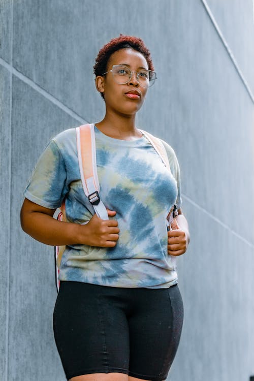 Free Woman Wearing a Crew Neck T-Shirt and Black Shorts Standing Stock Photo
