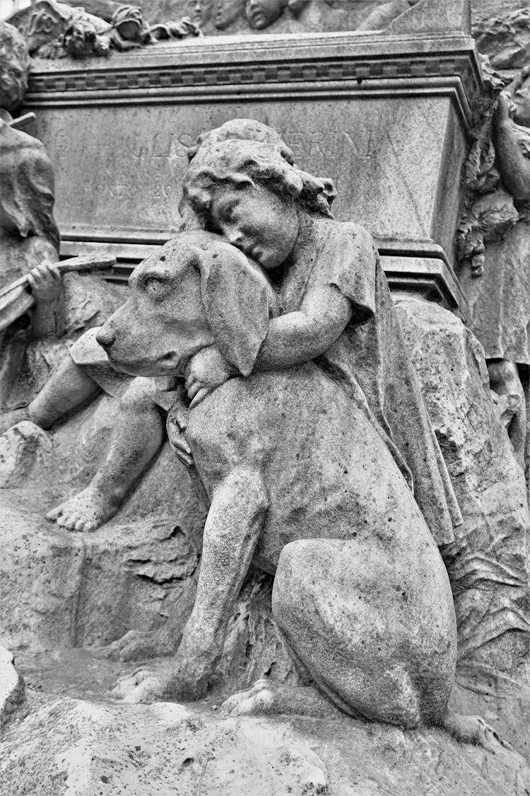 Statue Of A Kid Hugging The Dog 