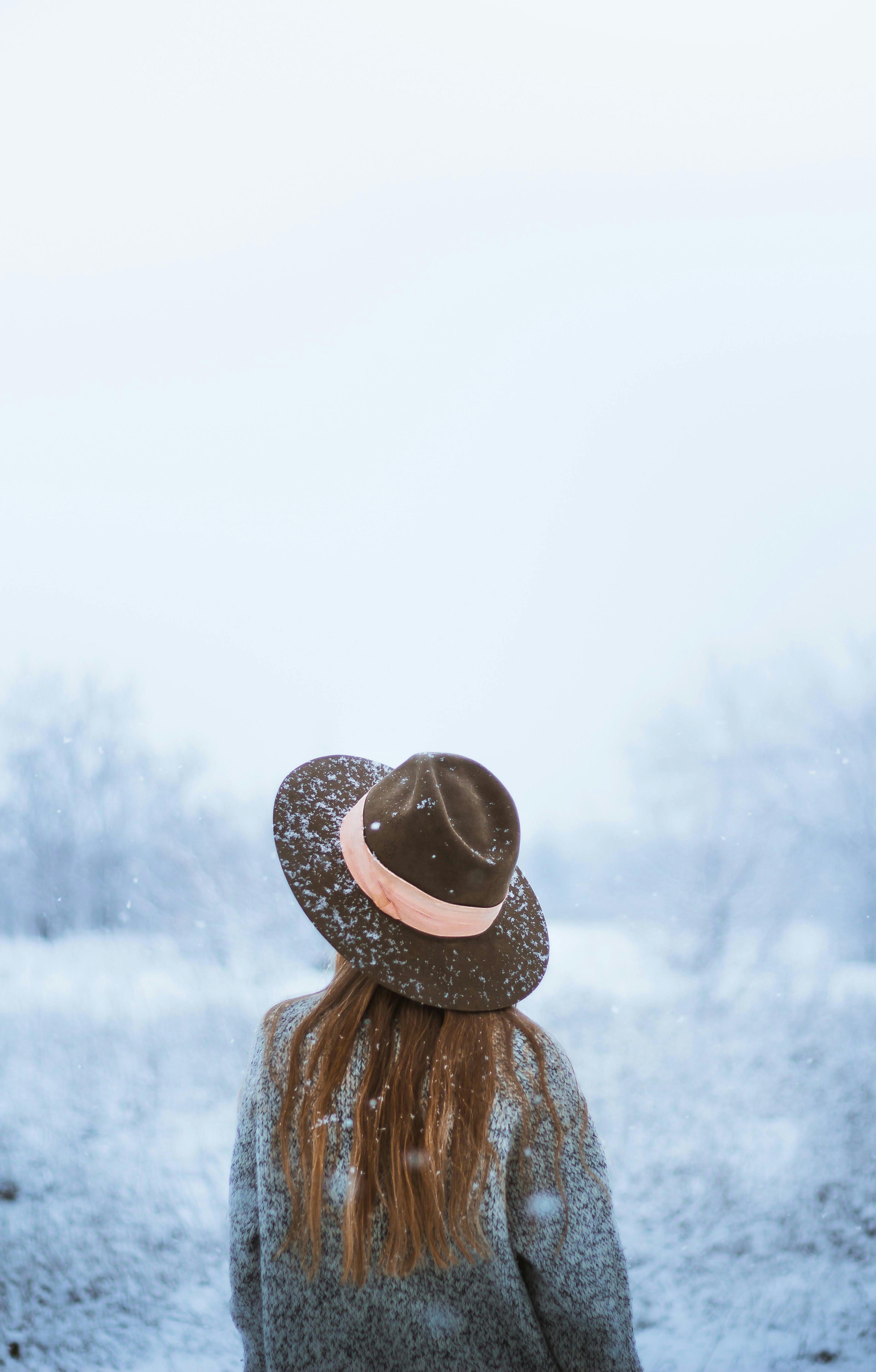 woman enjoying winter landscape in gloomy day